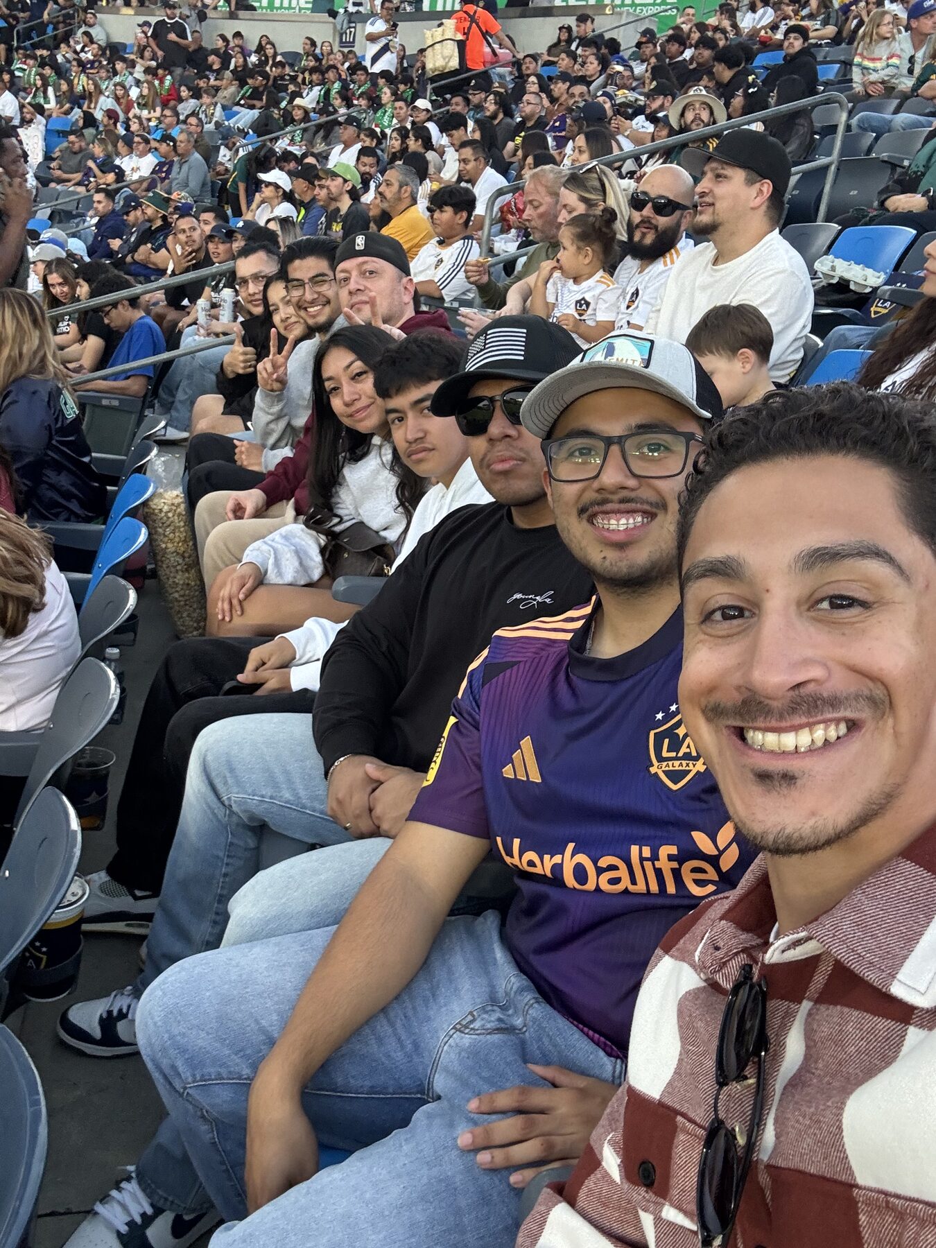 LSBA members smiling in the stands at an LA Galaxy soccer match.